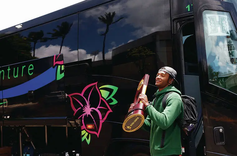 NCAA championship trophy in hand, the Rainbow Warriors return to Manoa